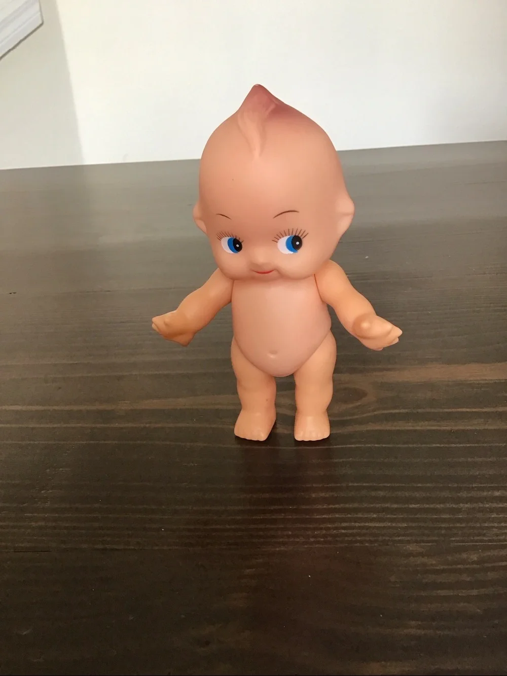 Vintage unmarked 6-inch hard plastic Kewpie doll from the mid-century era